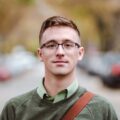 Young man with glasses outdoors on street